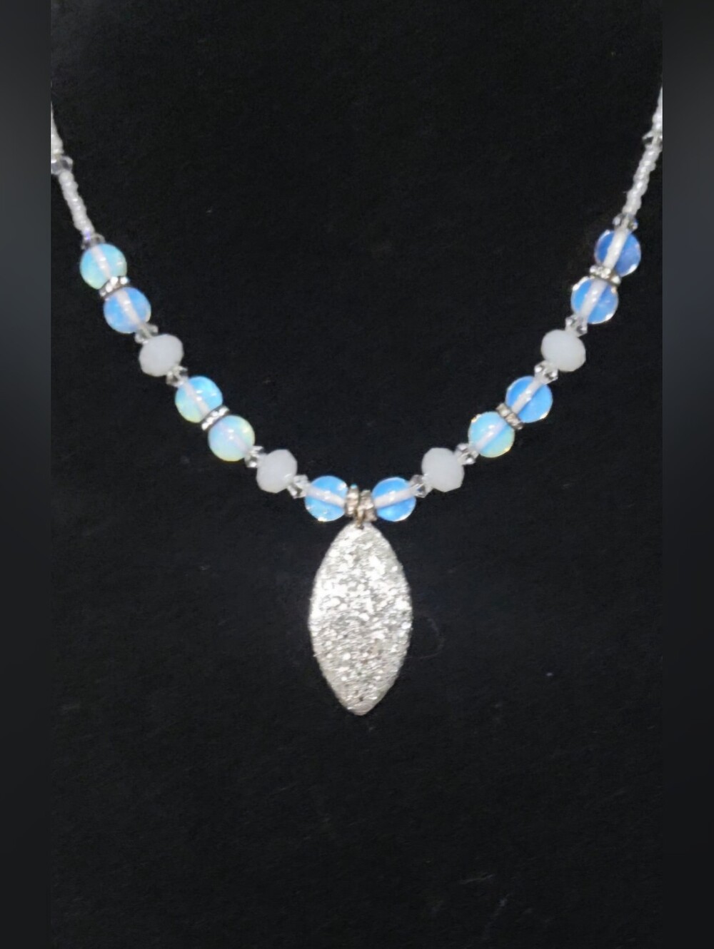Handcrafted Opalescent Bead Necklace with Sparkling Silver Pendant.